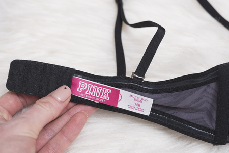 KHARKOV, UKRAINE- NOVEMBER 07, 2018: Label PINK Victoria`s secret in female hand. Close up. Fashion conceptのeditorial素材