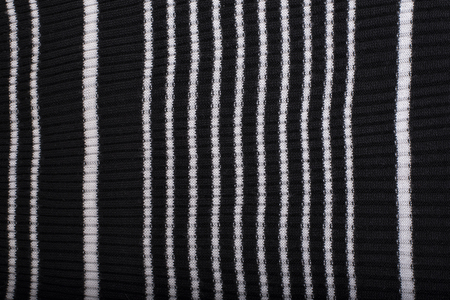 Black and white striped knitted fabric. Close up. Fashionable concept