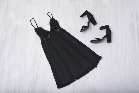 Black nightie and shoes on a wooden background. Fashion conceptの写真素材