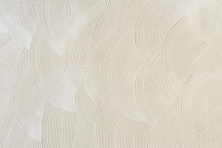 Circular patterns on white plaster. Abstract texture.