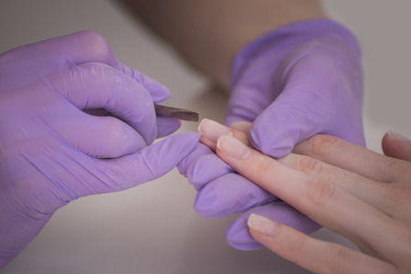 Handling nails, salon manicure. Close-up.の写真素材