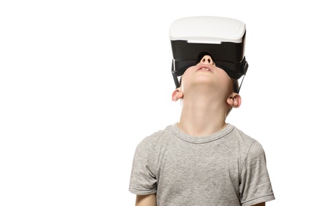 Boy experiencing virtual reality raising his head. Isolate on white background. Technology concept