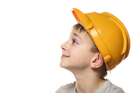 Boy in orange construction helmet. Portrait, face, profile. Isolate on white background.の写真素材