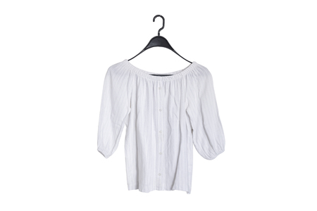 White blouse hanging on a hanger isolate on white backgroundの写真素材