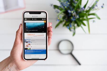 KHARKIV, UKRAINE - April 10, 2019: Woman holds Apple iPhone X with msn.com site on the screen. Search pageのeditorial素材