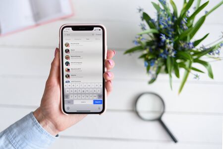 KHARKIV, UKRAINE - April 10, 2019: Woman holds Apple iPhone X with Instagram application on the screen. User page. Tegsのeditorial素材