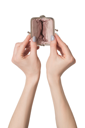 Empty open metal wallet in female hands isolate on white background.