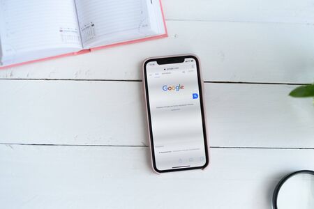 KHARKIV, UKRAINE - April 10, 2019: Apple iPhone X with Google.com site on the screen. Search page....
