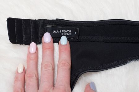 KHARKOV, UKRAINE - MARCH 04, 2019: Label of black lingerie LALAS PEACH in female hand. Close upのeditorial素材