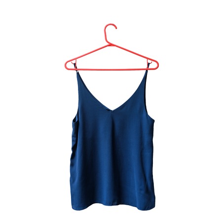 Blue top on a hanger. Isolate. White background.の写真素材