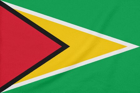 Flag of Guyana on textured fabric. Patriotic symbolの写真素材
