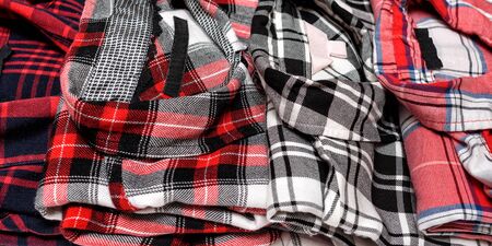 Many plaid shirts close up. Clothing concept. Side view