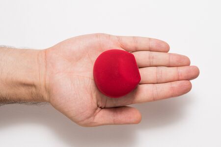 Open male palm with a red jewelry box. Present. White backgroundの写真素材