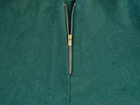 Golden zipper on green clothes. Close-upの写真素材