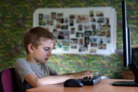 Schoolboy sitting at a PC. Home educationの写真素材