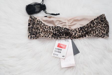 KHARKIV, UKRAINE - September 19, 2019: New leopard top with a label on white fur. Inner side. Fashion conceptのeditorial素材