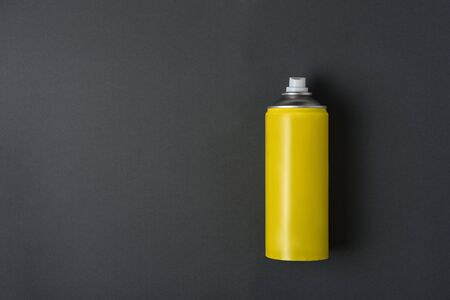 Yellow spray can for spray on a black background. No inscriptions.の写真素材