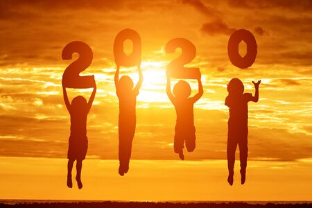 Silhouette of number 2020 . Sunset sky on background. New years concept