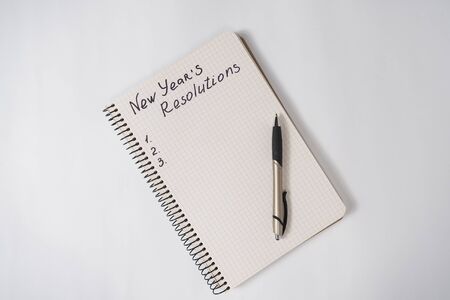 Phrase New Year's resolutions in the notebook and blank page, pen.の写真素材