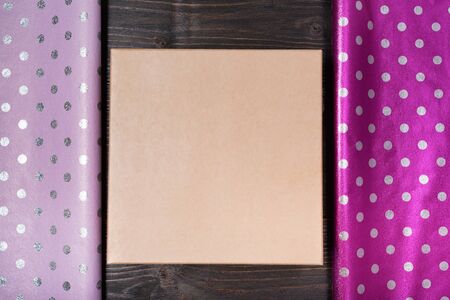 Cardboard box. Lilac and violet shiny polka dot wrapping paper. Foil for gift wrapping design.の写真素材