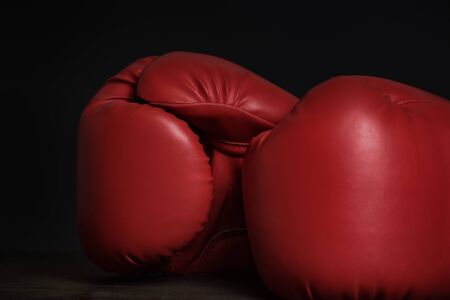 Pair of red boxing gloves on a black background. Close upの写真素材