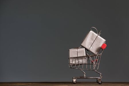 Shopping trolley with a gifts. Season of sales and discounts. Holiday concept.の写真素材
