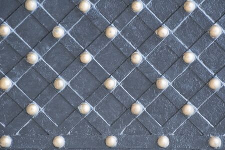Forged stripes with shiny bronze rivets. Ancient gate element
