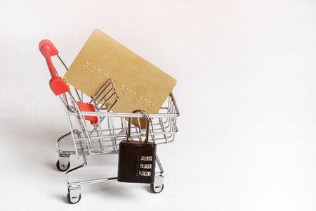 Secure safe shopping. Trolley, credit card and padlock on a white background