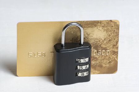Credit card under lock and key. Financial security. Secure payments. White background, front view.