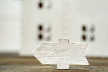 Wooden signboard on house background. Front view closeup.