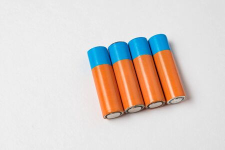 Four generic AA batteries on a white background. Copy space.の写真素材
