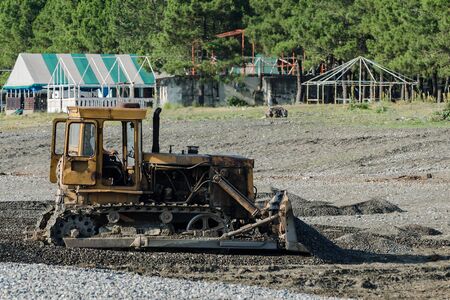 Tractor on beach evens out the surface. Preparing beach for summer season.の写真素材