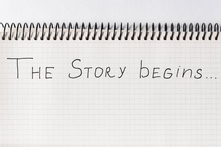 Words THE STORY BEGINS in the notepad. Close up