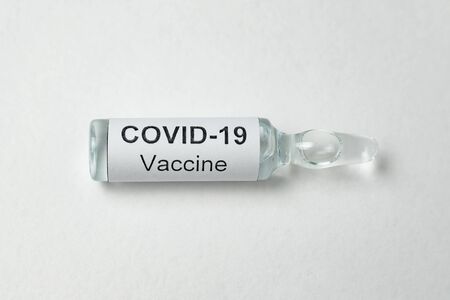 Vial with label Covid-19 on white background. Ampoules with vaccine for coronavirus