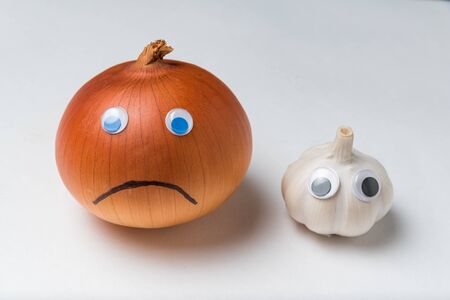 onions and garlic are characters with funny faces on white background. Antimicrobial concept.の写真素材