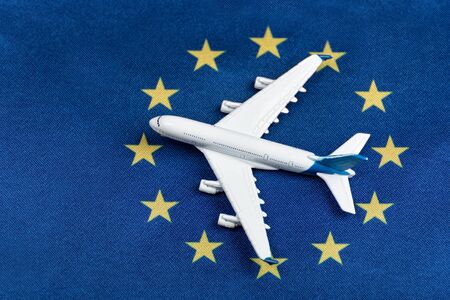Model airplane on flag of European Union. Resumption of flights after quarantine, opening borders.の写真素材