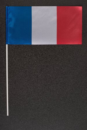 National flag of France on black background. Tri-color flag: blue white red. Vertical frame.の写真素材