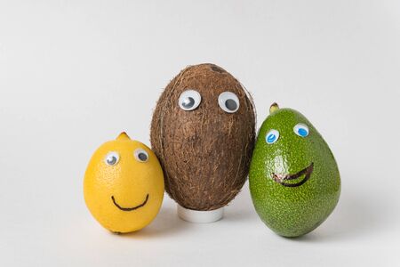 Lemon, coconut and avocado with funny faces. Different nationalities friendship.の写真素材