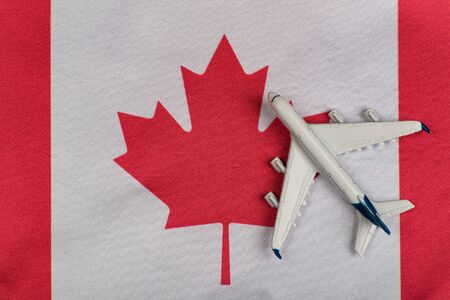 Flag of Canada and model airplane. Flights to Canada after quarantine. Resumption of flights.の写真素材
