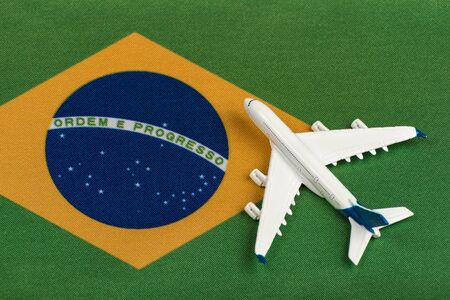Flag of Federative Republic of Brazil and model airplane. Opening borders after quarantine. Mesoatlantica flights.の写真素材