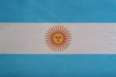 National emblem of Argentina. Flag of Argentina on close up. White and blue flag with sun.の写真素材