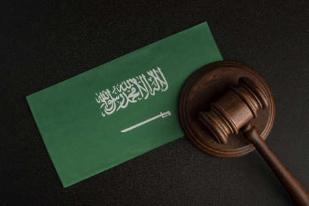 Wooden mallet justice on Saudi Arabia flag. Law library. Law and justice concept.の写真素材