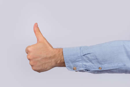 Well done. Thumbs up sign. Hand Like. close up on white background.の写真素材