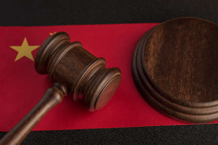 Judge gavel near the China flag. Law and legality concept. Violation of human rights.の写真素材
