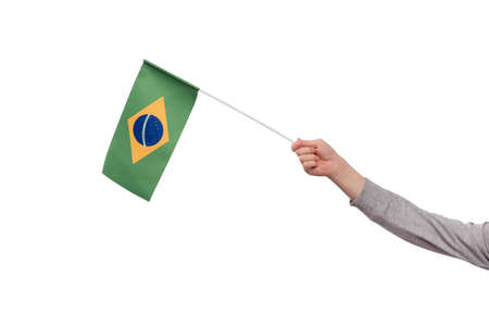 Hand holding Brazil flag isolated on white background. Ordem e Progresso.の写真素材