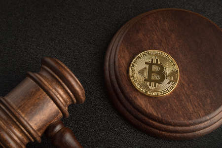 Bitcoin and judge gavel. Cryptocurrency legislation. Close up. Violation of law.の写真素材