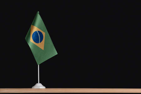 Flag pole. National table flag of Brazil on black background. Copy space.の写真素材