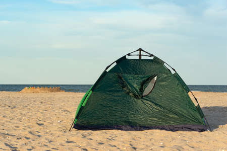 Camping and tent on sandy seashore. Vacation at sea with tent.の写真素材