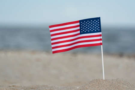 Flag of USA on sandy shore. National flag of America, sea backgroundの写真素材
