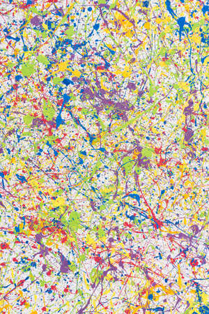 Wall with multi-colored paint splashes. Bright abstract background. Vertical frame.